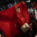 
              FILE - Morocco fans in Marseille, southern France, celebrate after victory over Spain in the round of 16 soccer match between Morocco and Spain, Tuesday, Dec. 6, 2022. (AP Photo/Daniel Cole, File)
            