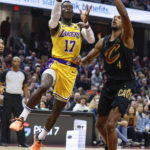 
              Los Angeles Lakers guard Dennis Schroder (17) shoots against Cleveland Cavaliers forward Evan Mobley (4) during the first half of an NBA basketball game Tuesday, Dec. 6, 2022, in Cleveland. (AP Photo/Ron Schwane)
            