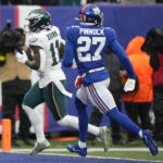 
              Philadelphia Eagles wide receiver A.J. Brown (11) crosses the goal line for at touchdown against New York Giants cornerback Jason Pinnock (27) during the second quarter of an NFL football game, Sunday, Dec. 11, 2022, in East Rutherford, N.J. (AP Photo/Bryan Woolston)
            