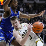 
              Purdue guard Fletcher Loyer (2) falls as he drives around New Orleans guard Jordan Johnson (1) during the second half of an NCAA college basketball game in West Lafayette, Ind., Wednesday, Dec. 21, 2022. (AP Photo/Michael Conroy)
            