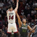 
              Miami Heat guard Tyler Herro (14) shoots as Minnesota Timberwolves guard Bryn Forbes (10) defends during the first half of an NBA basketball game, Monday, Dec. 26, 2022, in Miami. (AP Photo/Lynne Sladky)
            