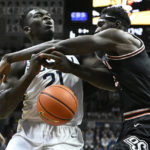 
              Connecticut's Adama Sanogo (21) is fouled by Oklahoma State's Moussa Cisse, right, in the first half of an NCAA college basketball game, Thursday, Dec. 1, 2022, in Storrs, Conn. (AP Photo/Jessica Hill)
            