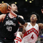 
              Los Angeles Clippers center Ivica Zubac (40) drives as Toronto Raptors forward Scottie Barnes (4) defends during the first half of an NBA basketball game Tuesday, Dec. 27, 2022, in Toronto. (Frank Gunn/The Canadian Press via AP)
            
