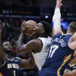 
              Minnesota Timberwolves guard Anthony Edwards (1) drives to the basket between New Orleans Pelicans forward Zion Williamson (1) and center Jonas Valanciunas (17) in the first half of an NBA basketball game in New Orleans, Wednesday, Dec. 28, 2022. (AP Photo/Gerald Herbert)
            