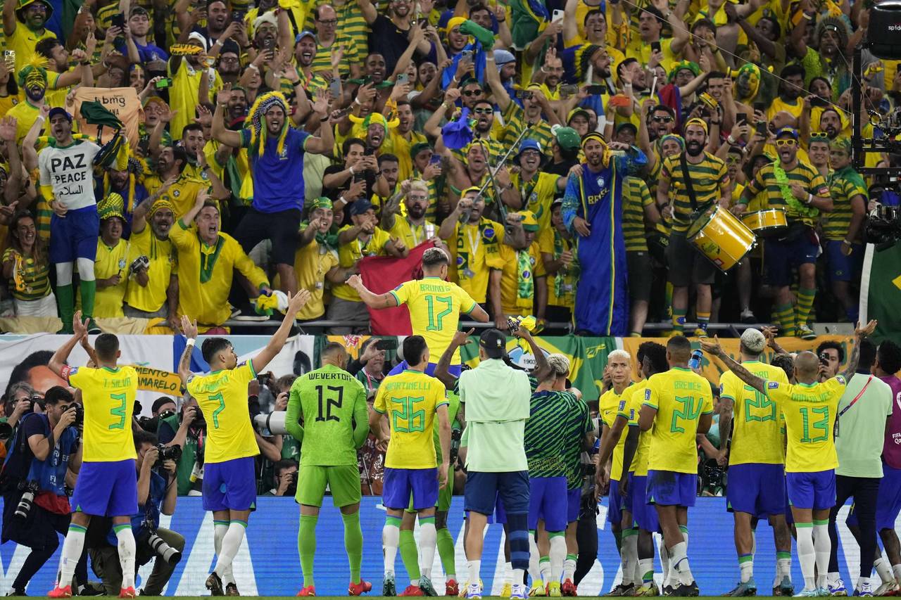 Fans of Brazil cheer their team after the World Cup round of 16 soccer match between Brazil and Sou...
