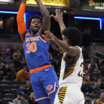 
              New York Knicks forward Julius Randle (30) shoots over Indiana Pacers forward Aaron Nesmith during the first half of an NBA basketball game in Indianapolis, Sunday, Dec. 18, 2022. (AP Photo/AJ Mast)
            