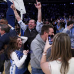 
              North Carolina fans celebrate as forward Pete Nance (32) tied the score at the close of the second half during an NCAA college basketball game against Ohio State in the CBS Sports Classic, Saturday, Dec. 17, 2022, in New York. The Tar Heels won 89-84 in overtime. (AP Photo/Julia Nikhinson)
            