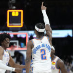 
              Oklahoma City Thunder guard Shai Gilgeous-Alexander (2) celebrates with teammates Jalen Williams, left, and Luguentz Dort, right, after hitting the game winning shot against the Portland Trail Blazers in an NBA basketball game Monday, Dec. 19, 2022, in Oklahoma City. (AP Photo/Sue Ogrocki)
            