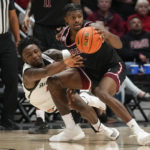 
              Troy guard Darius McNeill, right, looks to pass as San Diego State forward Demarshay Johnson Jr. falls during the first half of an NCAA college basketball game Monday, Dec. 5, 2022, in San Diego. (AP Photo/Gregory Bull)
            