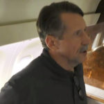 
              In this image taken from video provided by RU-24 Russian Television on Friday, Dec. 9, 2022, Russian citizen Viktor Bout who was exchanged for U.S. basketball player Brittney Griner, speaks in a Russian plane after a swap, in the airport of Abu Dhabi, United Arab Emirates. Russian arms dealer Bout, who was released from U.S. prison in exchange for WNBA star Griner, is widely labeled abroad as the "Merchant of Death" who fueled some of the world's worst conflicts but seen at home as a swashbuckling businessman unjustly imprisoned after an overly aggressive U.S. sting operation. (RU-24 Russian Television via AP)
            