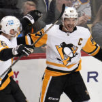 
              Pittsburgh Penguins' Sidney Crosby (87) celebrates his goal against the Buffalo Sabres with Marcus Pettersson during the third period of an NHL hockey game in Pittsburgh, Saturday, Dec. 10, 2022. (AP Photo/Gene J. Puskar)
            