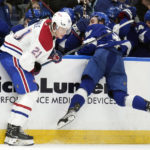 
              Montreal Canadiens defenseman Kaiden Guhle (21) checks Tampa Bay Lightning left wing Brandon Hagel (38) into the boards during the second period of an NHL hockey game Wednesday, Dec. 28, 2022, in Tampa, Fla. (AP Photo/Chris O'Meara)
            