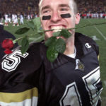 
              FILE - Purdue quarterback Drew Brees celebrates his team's 41-13 win over Indiana in West Lafayette, Ind., Saturday, Nov. 18, 2000. Purdue athletic director Mike Bobinski announced Brees would return to the campus in West Lafayette, Indiana, as an assistant coach to help the Boilermakers prepare for their Jan. 2 Citrus Bowl game against No. 17 LSU. (AP Photo/Tom Strattman, File)
            