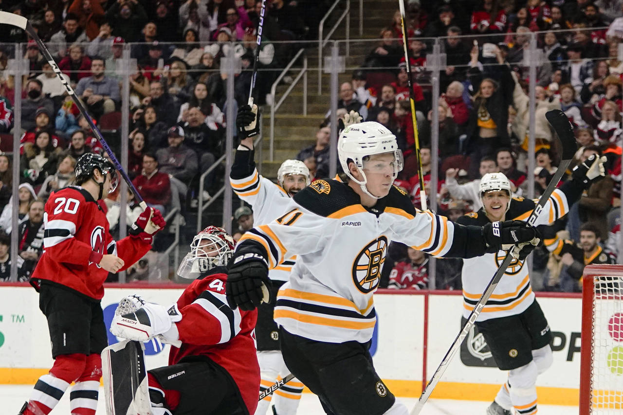 Boston Bruins' Trent Frederic (11) celebrates after scoring as New Jersey Devils goaltender Vitek V...
