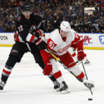 
              Detroit Red Wings defenseman Moritz Seider (53) is stick-checked by Buffalo Sabres center Tage Thompson (72) during the first period of an NHL hockey game Thursday, Dec. 29, 2022, in Buffalo, N.Y. (AP Photo/Jeffrey T. Barnes)
            