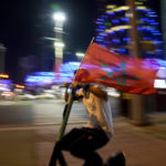 
              A fan rides a scooter carrying a flag of Morococo in Doha, Qatar, Tuesday, Dec. 6, 2022, after Morocco defeated Spain in a penalty shootout in a World Cup soccer match and qualified to the quarterfinals.
            
