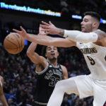 
              New Orleans Pelicans center Willy Hernangomez (9) battles under the basket against San Antonio Spurs guard Tre Jones (33) in the second half of an NBA basketball game in New Orleans, Thursday, Dec. 22, 2022. The Pelicans won 126-117. (AP Photo/Gerald Herbert)
            