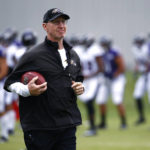 
              FILE - Baltimore Ravens special teams coordinator and associate head coach Jerry Rosburg walks on the field during NFL football training camp in Owings Mills, Md., July 29, 2017. Several years after giving up his dream of ever becoming a head coach, Rosburg was asked to lead the Denver Broncos over the final two weeks of the season following Nathaniel Hackett's dismissal. (AP Photo/Patrick Semansky, File)
            