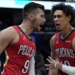 
              New Orleans Pelicans center Willy Hernangomez (9) reacts with center Jaxson Hayes after being fouled on a 3-point play in the first half of an NBA basketball game against the Philadelphia 76ers in New Orleans, Friday, Dec. 30, 2022. (AP Photo/Gerald Herbert)
            