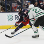 
              Columbus Blue Jackets' Kirill Marchenko, left, looks for an open shot as Dallas Stars' Esa Lindell defends during the second period of an NHL hockey game on Monday, Dec. 19, 2022, in Columbus, Ohio. (AP Photo/Jay LaPrete)
            