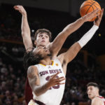 
              Arizona State guard Frankie Collins, right, gets off a shot against Stanford forward Maxime Raynaud during the second half of an NCAA college basketball game in Tempe, Ariz, Sunday, Dec. 4, 2022. Arizona State won 68-64. (AP Photo/Ross D. Franklin)
            