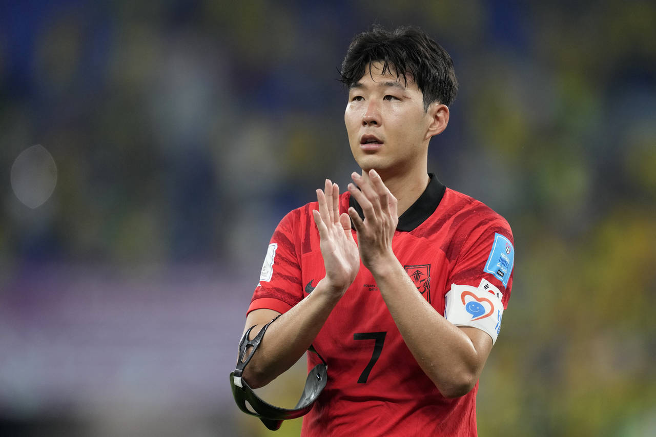 South Korea's Son Heung-min applauds the fans after losing 4-1 during the World Cup round of 16 soc...