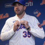 
              New York Mets baseball pitcher Justin Verlander puts on his new jersey during a news conference at Citi Field, Tuesday, Dec. 20, 2022, in New York. The team introduced Verlander after they agreed to a $86.7 million, two-year contract. It's part of an offseason spending spree in which the Mets have committed $476.7 million on seven free agents. (AP Photo/Seth Wenig)
            