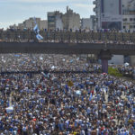 
              Argentina soccer fans crowd a highway for a homecoming parade for the players who won the World Cup title, in Buenos Aires, Argentina, Tuesday, Dec. 20, 2022. (AP Photo/Gustavo Garello)
            