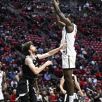 
              San Diego State forward Nathan Mensah (31) shoots over Occidental forward Bernard Cassidy during the first half of an NCAA college basketball game Friday, Dec. 2, 2022, in San Diego. (AP Photo/Denis Poroy)
            