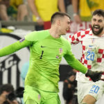 
              Croatia's goalkeeper Dominik Livakovic celebrates his team victory over Brazil after the penalty shootout in the World Cup quarterfinal soccer match between Croatia and Brazil, at the Education City Stadium in Al Rayyan, Qatar, Friday, Dec. 9, 2022. (AP Photo/Andre Penner)
            