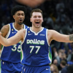
              Dallas Mavericks guard Luka Doncic (77) celebrates scoring the game tying basket in front of teammate Christian Wood (35) during the fourth quarter of an NBA basketball game against the New York Knicks in Dallas, Tuesday, Dec. 27, 2022. The Mavericks won in overtime 126-121. (AP Photo/LM Otero)
            