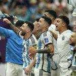 
              Argentina's Lionel Messi, left, celebrates with teammates after defeating the Netherlands off penalties during the World Cup quarterfinal soccer match between the Netherlands and Argentina, at the Lusail Stadium in Lusail, Qatar, Saturday, Dec. 10, 2022. (AP Photo/Francisco Seco)
            