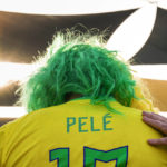 
              A man puts his hand on the shoulder of a fan wearing a shirt in support of Pelé at a Brazilian fan party before the the World Cup round of 16 soccer match between Brazil and South Korea, in Doha, Dec. 5, 2022. The 82-year-old Pelé remained in a hospital in San Paulo recovering from a respiratory infection that was aggravated by COVID-19, but the news coming from Brazil early Monday was good. (AP Photo/Ashley Landis)
            