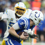 
              Indianapolis Colts quarterback Nick Foles (9) is sacked by Los Angeles Chargers' Khalil Mack (52) during the second half of an NFL football game, Monday, Dec. 26, 2022, in Indianapolis. (AP Photo/Michael Conroy)
            