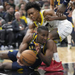 
              Utah Jazz guard Collin Sexton (2) defends against Indiana Pacers forward Aaron Nesmith, bottom, during the second half of an NBA basketball game Friday, Dec. 2, 2022, in Salt Lake City. (AP Photo/Rick Bowmer)
            