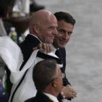 
              FILE - French President Emmanuel Macron, right, stands with FIFA President Gianni Infantino prior to the start of the World Cup semifinal soccer match between France and Morocco at the Al Bayt Stadium in Al Khor, Qatar, on Dec. 14, 2022. Macron is about to jet off to Qatar for the second time in a week, despite broad concerns about the emirate's human rights and environmental record. Why? Because France is in the World Cup final, and Macron really is a big football fan — as well as a prominent advocate of the longstanding partnership between the two countries. (AP Photo/Thanassis Stavrakis, File)
            