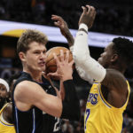 
              Orlando Magic center Moritz Wagner (21) pulls down rebound as he is defended by Los Angeles Lakers guard Dennis Schroder (17) during the first half of an NBA basketball game, Tuesday, Dec. 27, 2022, in Orlando, Fla. (AP Photo/Kevin Kolczynski)
            