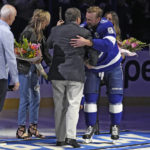 
              Tampa Bay Lightning center Steven Stamkos (91) hugs team owner Jeff Vinik after being presented with a gold hockey stick before an NHL hockey game against the Toronto Maple Leafs Saturday, Dec. 3, 2022, in Tampa, Fla. Stamkos recorded his 1,000th career point earlier in the week. (AP Photo/Chris O'Meara)
            