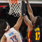 
              Atlanta Hawks forward Onyeka Okongwu dunks over Oklahoma City Thunder forward Ousmane Dieng during the first half of an NBA basketball game, Monday, Dec. 5, 2022, in Atlanta. (AP Photo/Hakim Wright Sr.)
            