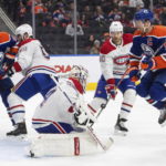
              Montreal Canadiens goalie Jake Allen (34) makes the save as Edmonton Oilers' Connor McDavid (97) jumps during the second period of an NHL hockey game, Saturday, Dec. 3, 2022 in Edmonton, Alberta. (Jason Franson/The Canadian Press via AP)
            