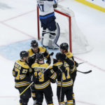
              Boston Bruins left wing Nick Foligno (17) is congratulated by teammates after his goal against Winnipeg Jets goaltender Connor Hellebuyck (37) during the third period of an NHL hockey game Thursday, Dec. 22, 2022, in Boston. (AP Photo/Mary Schwalm)
            