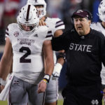 
              Mississippi State coach Mike Leach confers with quarterback Will Rogers (2) during the first half of the team's NCAA college football game against Mississippi in Oxford, Miss., Thursday, Nov. 24, 2022. (AP Photo/Rogelio V. Solis)
            