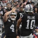 
              Las Vegas Raiders quarterback Derek Carr congratulates wide receiver Mack Hollins on his touchdown reception during the first half of an NFL football game between the New England Patriots and Las Vegas Raiders, Sunday, Dec. 18, 2022, in Las Vegas. (AP Photo/David Becker)
            