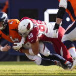 
              Arizona Cardinals defensive end J.J. Watt (99) sacks Denver Broncos quarterback Brett Rypien (4) during the first half of an NFL football game, Sunday, Dec. 18, 2022, in Denver. (AP Photo/Jack Dempsey)
            
