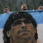 
              Fans hold a banner with the face of Argentinean soccer star Diego Maradona prior to the World Cup semifinal soccer match between Argentina and Croatia at the Lusail Stadium in Lusail, Qatar, Tuesday, Dec. 13, 2022. (AP Photo/Natacha Pisarenko)
            