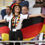 
              FILE - A woman wearing the German colors cheers on the tribune prior to the World Cup group E soccer match between Germany and Japan, at the Khalifa International Stadium in Doha, Qatar, Wednesday, Nov. 23, 2022. (AP Photo/Matthias Schrader, File)
            