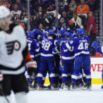 
              Tampa Bay Lightning players celebrate after an assist by Steven Stamkos on a goal by Nicholas Paul during the second period of an NHL hockey game against the Philadelphia Flyers, Thursday, Dec. 1, 2022, in Philadelphia. (AP Photo/Matt Slocum)
            