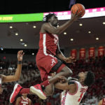 
              Alabama center Charles Bediako (14) is fouled by Houston guard Jamal Shead (1), right, during the first half of an NCAA college basketball game, Saturday, Dec. 10, 2022, in Houston. (AP Photo/Kevin M. Cox)
            