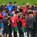 
              Moroccan players stand in a circle after the World Cup semifinal soccer match between France and Morocco at the Al Bayt Stadium in Al Khor, Qatar, Wednesday, Dec. 14, 2022. (AP Photo/Hassan Ammar)
            