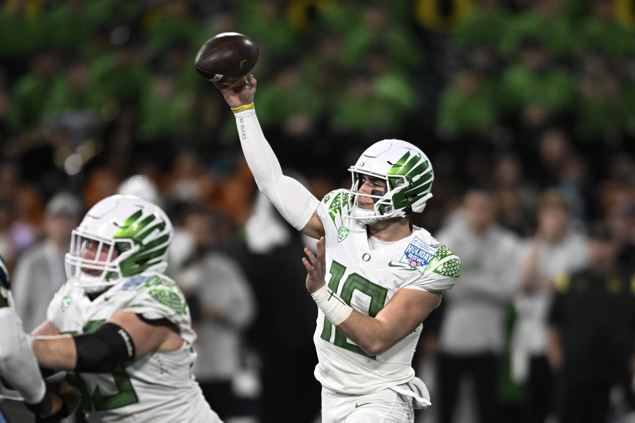 Oregon quarterback Bo Nix (10) passes during the first half of the Holiday Bowl NCAA college footba...